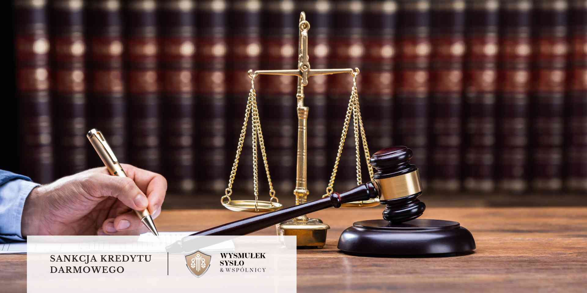 Młotek sędziowski i złota waga sprawiedliwości na tle regałów z grubymi księgami prawniczymi; po lewej ręka prawnika pisząca piórem.